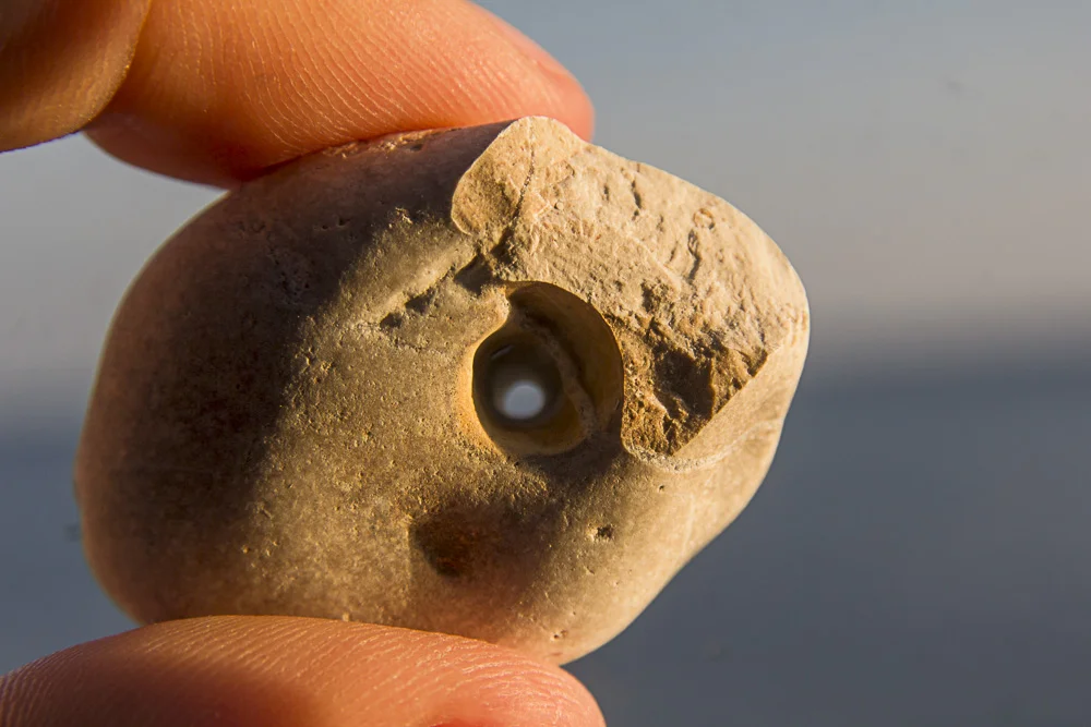 A rock with a hole in it - souvenir from Ristna beach Tour image